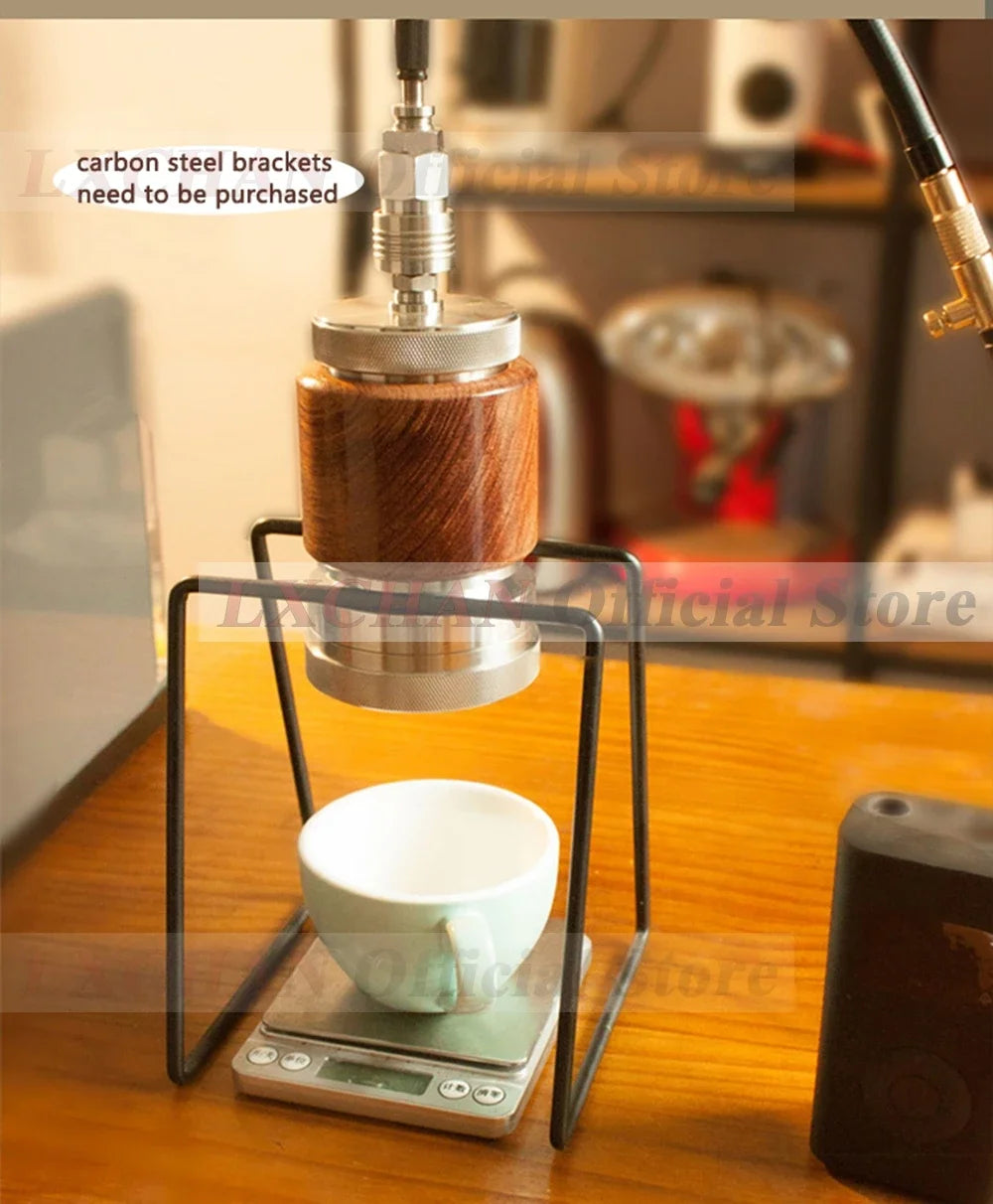 Manual pour-over coffee maker with walnut wood, stainless steel parts, and black frame on a digital scale.