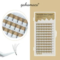 Premade fan lashes on a white tray, featuring delicate black synthetic fiber clusters for professional eye lash