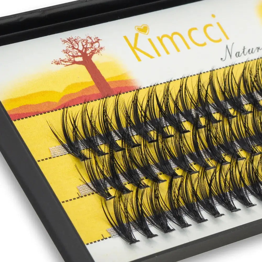 Black individual mink eyelash clusters in a 3D Russian volume style arranged in a storage tray.