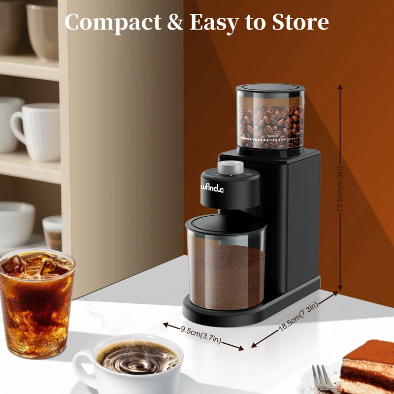 Wncle compact black electric coffee grinder with clear bean hopper and grounds container, 23.5cm tall, on kitchen table.
