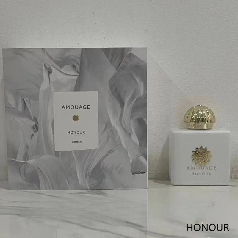 Amouage Honour Woman EDP: White square bottle with gold dome cap and box, long-lasting elegant floral feminine scent.