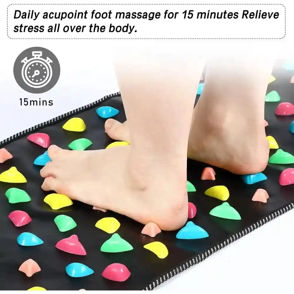 Person using colorful stone reflexology foot massage mat for acupressure therapy to relieve stress and pain.
