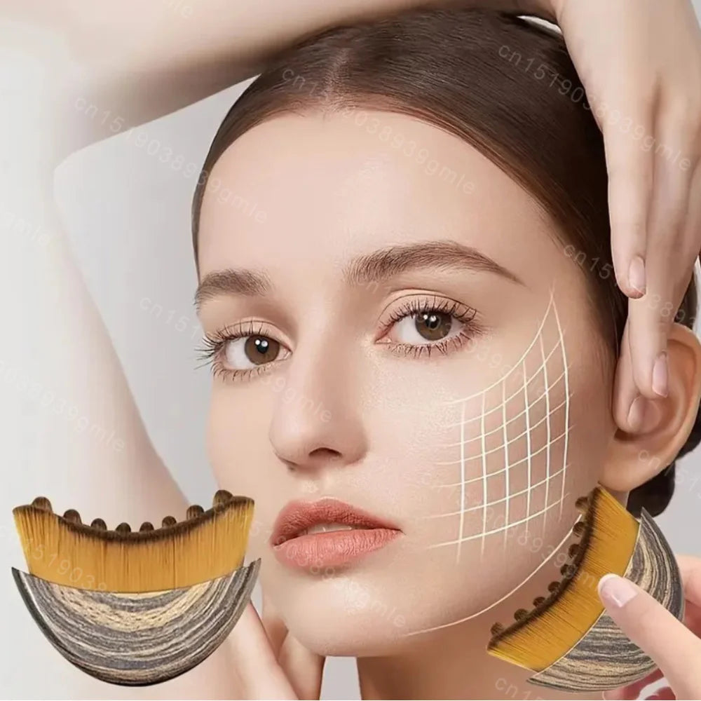 A curved, fan-shaped facial massage brush with wood-grain base and soft, dense yellow-tipped bristles.