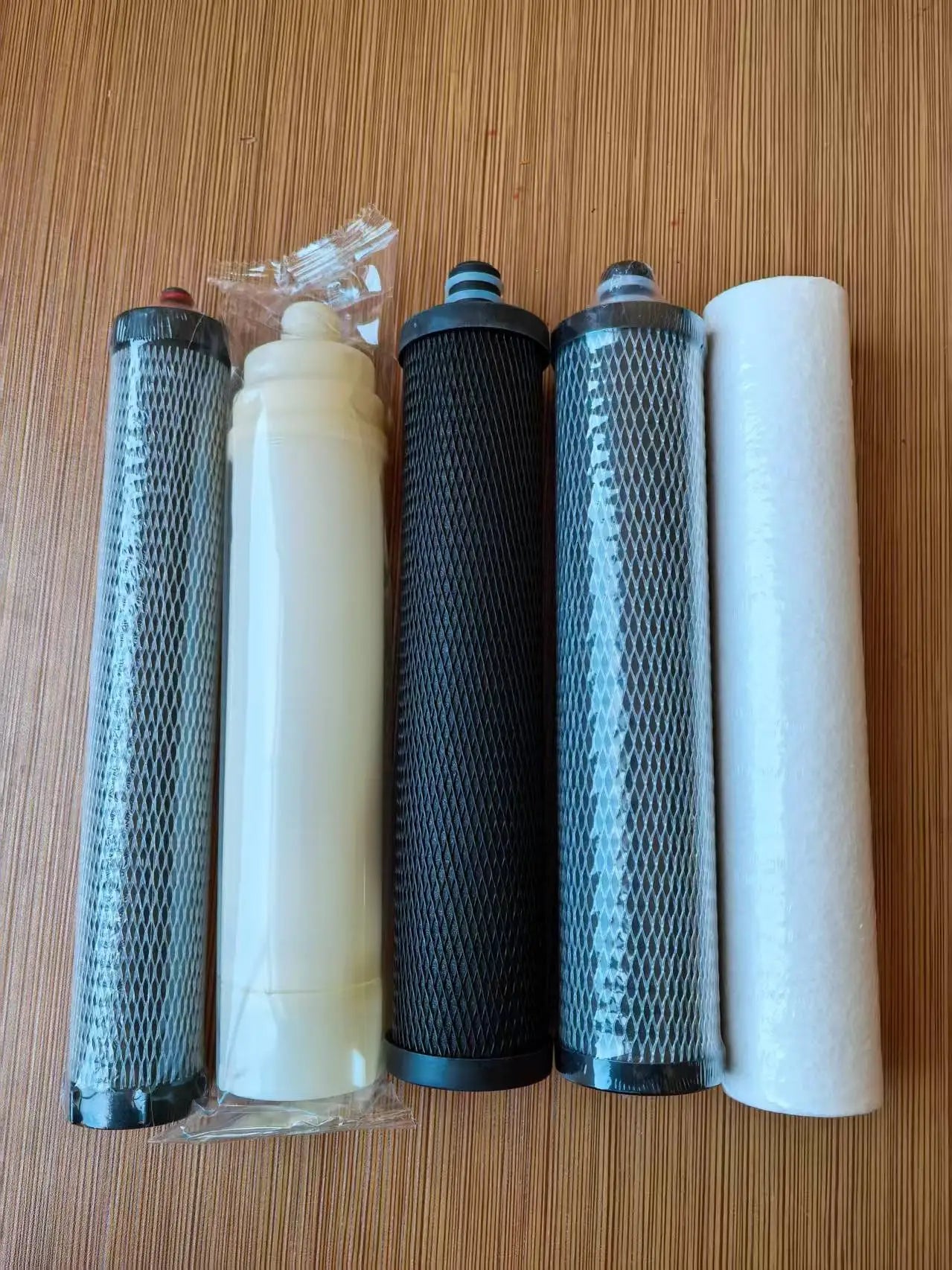 Set of assorted replacement filter cartridges with blue mesh, black core, and white housings