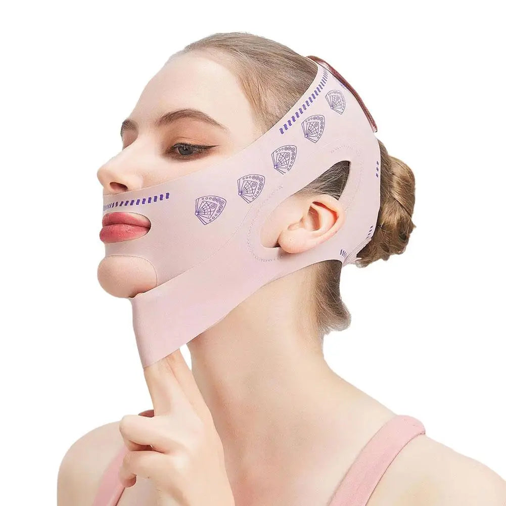 A woman wearing a pale pink face-slimming strap with purple fan patterns, designed to lift the chin and cheeks.