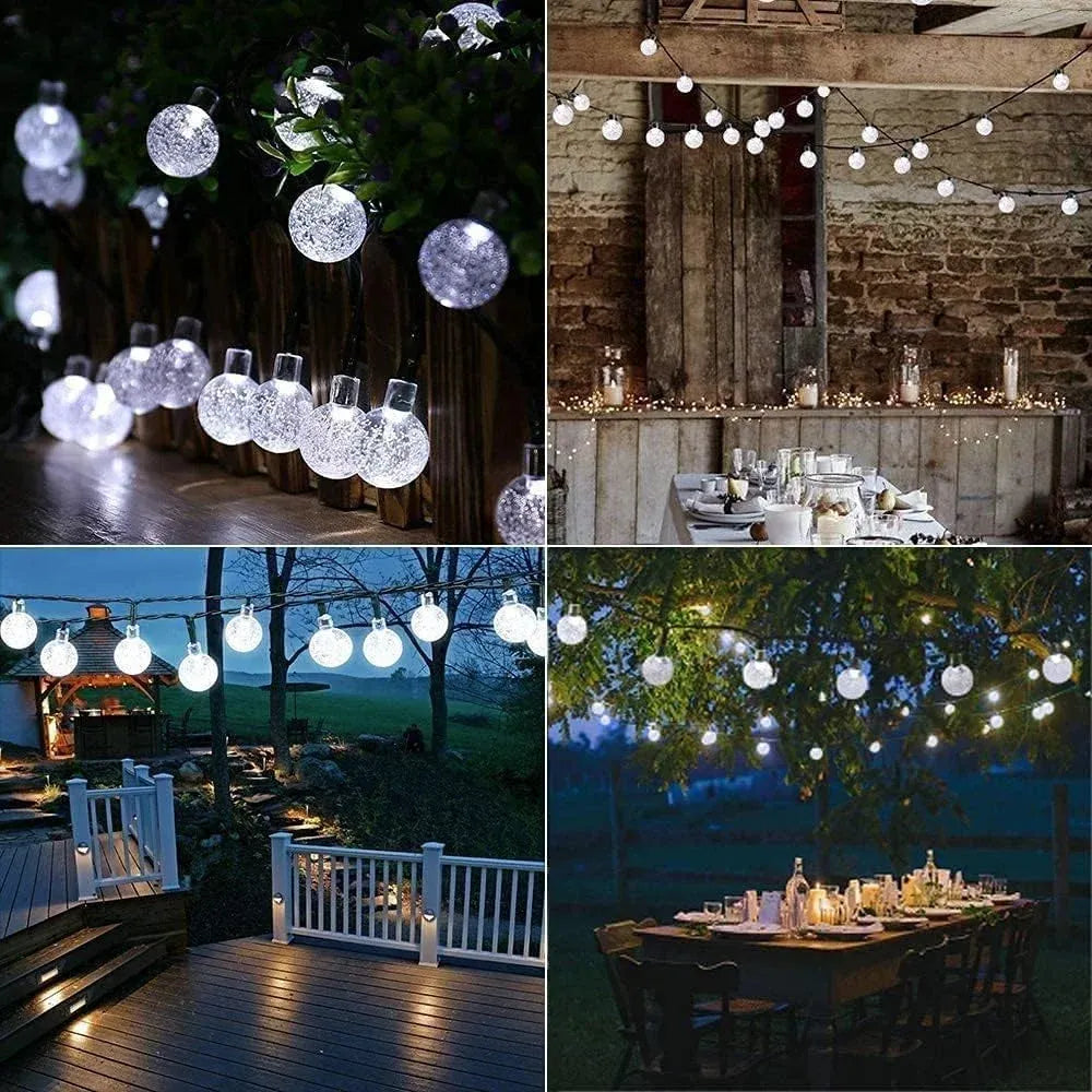 Cool white glitter globe LED string lights with round bulbs on patio and party tables.