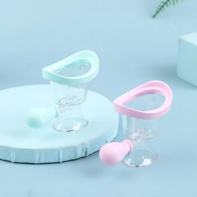 Reusable soft silicone eye wash cups in pastel pink and blue for gentle, effective eye flushing and cleaning.