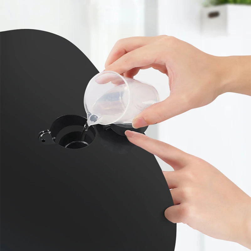 Filling water into a 7-color LED infrared light therapy facial mask for nano spray skin rejuvenation treatment.