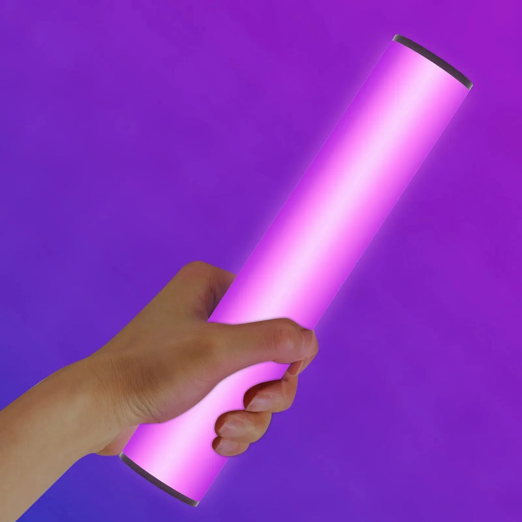 Handheld cylindrical LED light wand glowing vibrant purple, used for photography, video lighting, and creative effects.