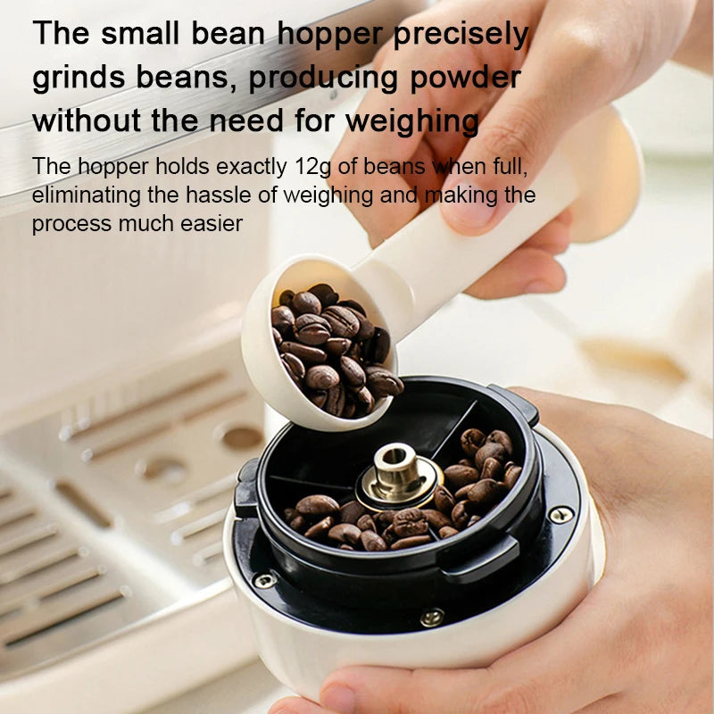White coffee bean grinder with 12g capacity hopper being filled by a measuring scoop for precise brewing.