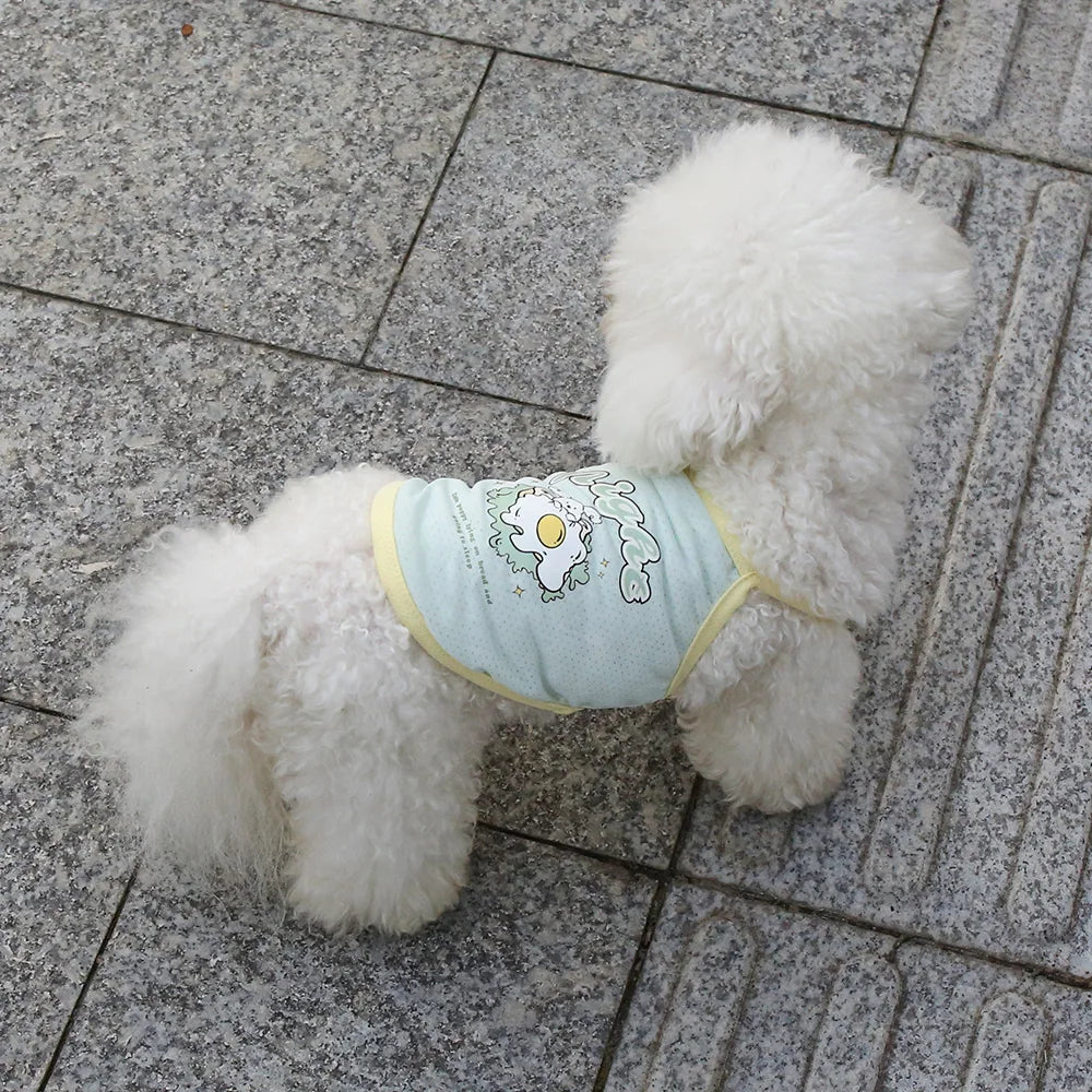 Small white dog wearing a breathable, light blue ice silk suspender shirt with a cute fried egg graphic for summer.