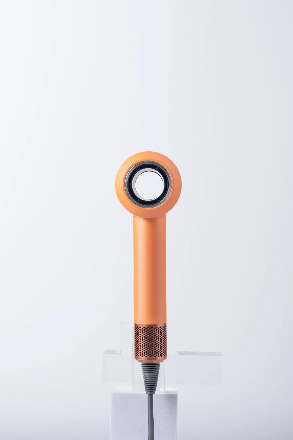 Orange high-speed brushless hair dryer with negative ion technology and sleek, modern ergonomic design.