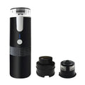 Black portable electric espresso maker with power indicator, textured grip, and removable coffee filter basket.