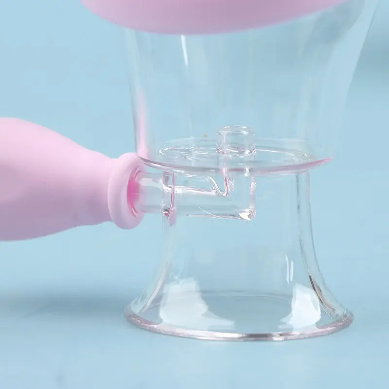 Reusable clear silicone eye wash cup with pink bulb for gentle eye cleaning, flushing, and rinsing at home.