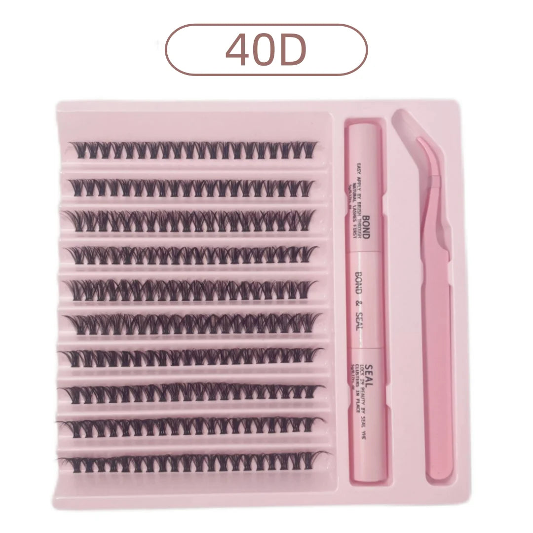 DIY lash kit in a pink tray featuring 40D cluster lashes, a dual-ended bond and seal glue, and curved tweezers.