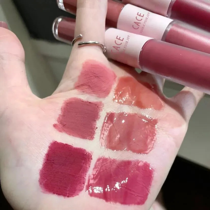 CACE double-head lip gloss swatches on hand showing matte lip mud and mirror water gloss in red and nude shades.