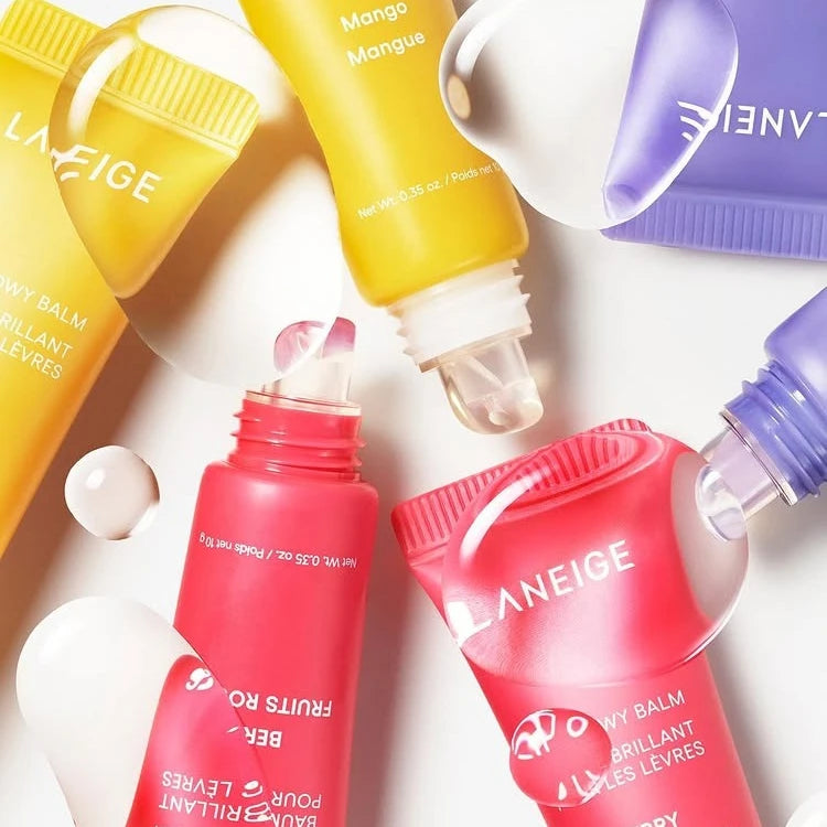 Laneige hydrating lip balms in yellow, pink, and purple tubes with glossy, smooth texture for daily lip care.