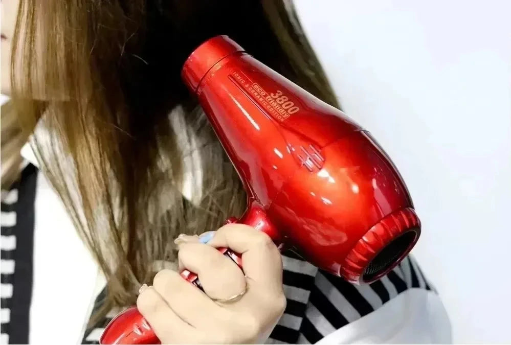 Shiny red 2100W ionic ceramic hair dryer for fast, professional styling with high-speed airflow and heat settings.