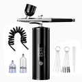 Portable black airbrush kit for nail art, makeup, and cake decorating with compressor, hose, and fluid cups.