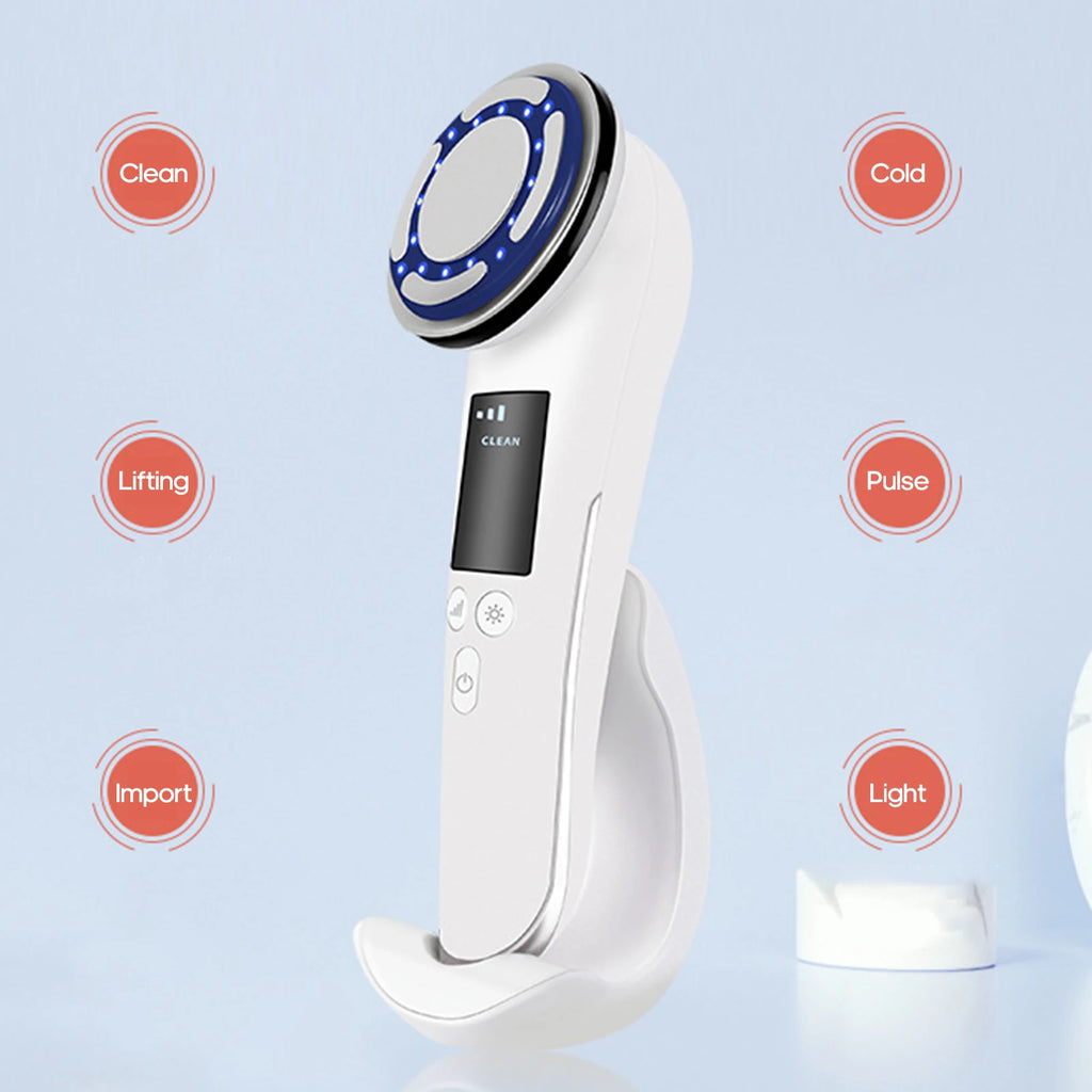 White hot and cold facial beauty device with LED light, EMS vibration, and charging base on a light blue background.