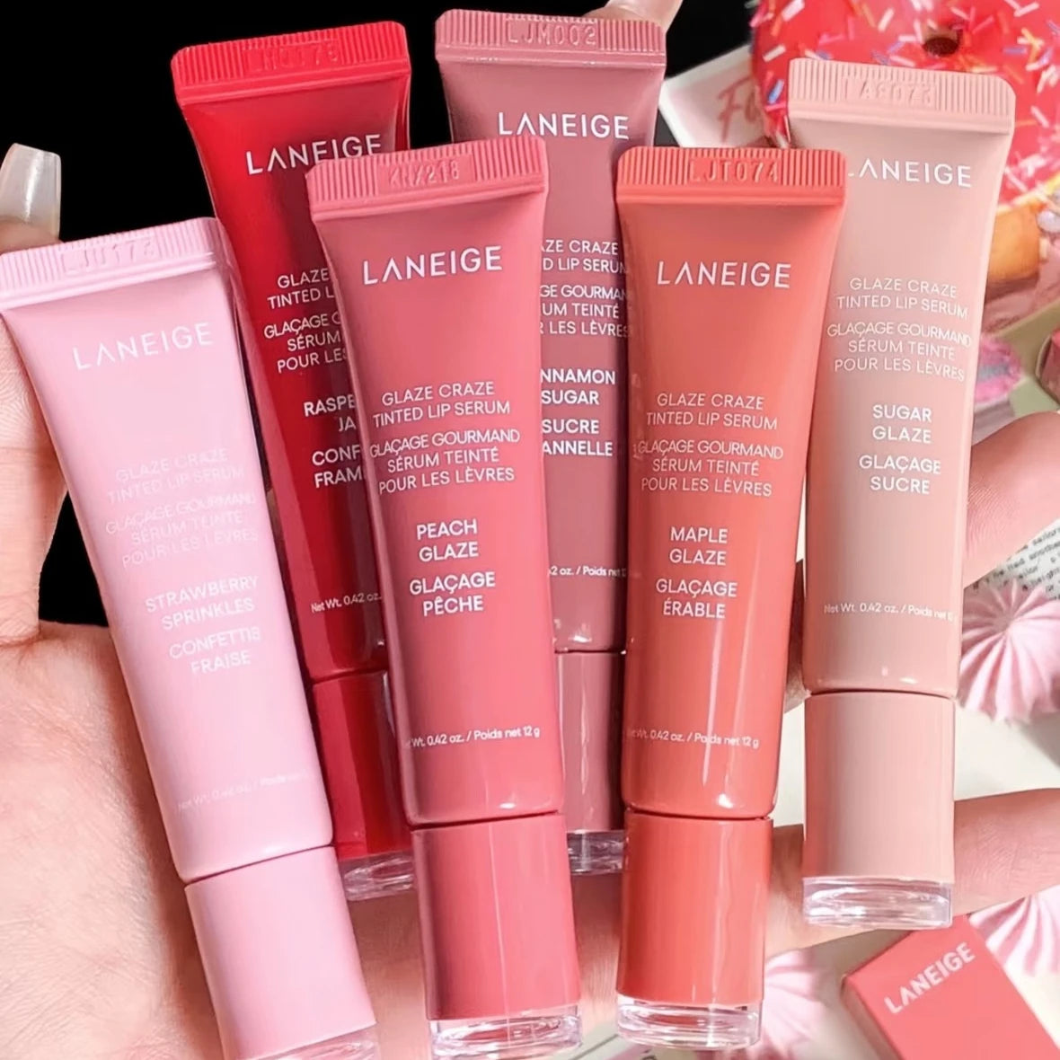 Laneige Glaze Craze Tinted Lip Serum collection in various shades, offering lightweight, hydrating glossy lip color.