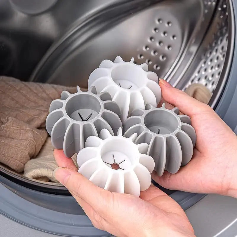 Reusable grey and white silicone laundry balls for removing pet hair from clothes in the washing machine.