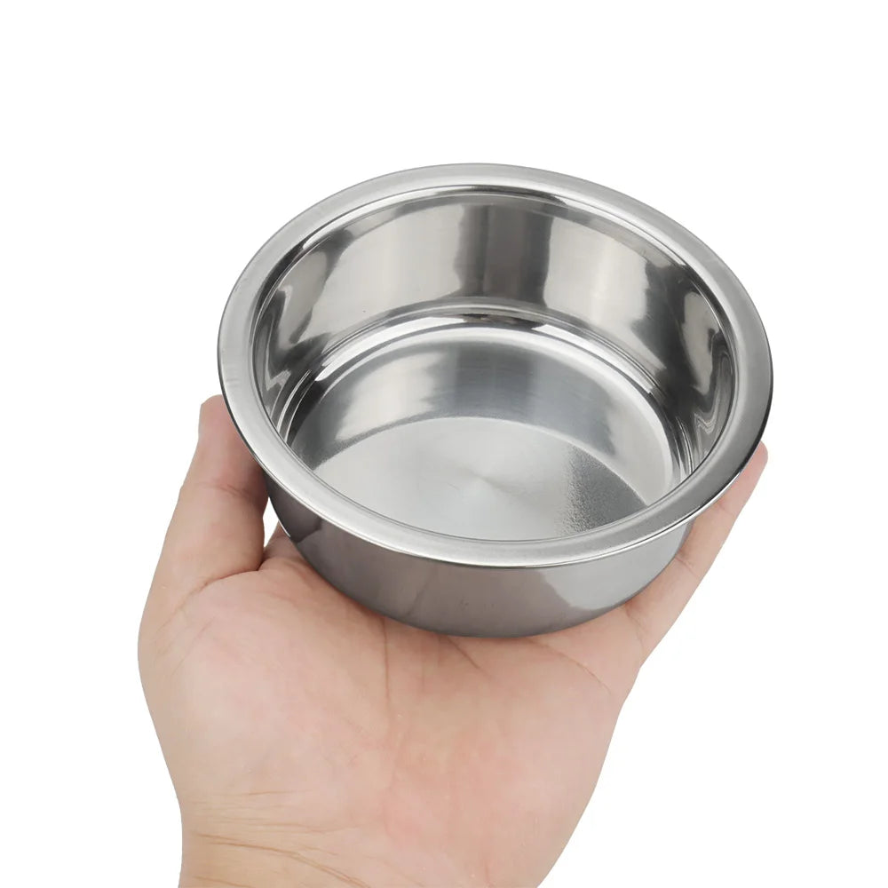 Hand holding a durable round stainless steel dog and cat bowl for easy feeding of small to medium pets.