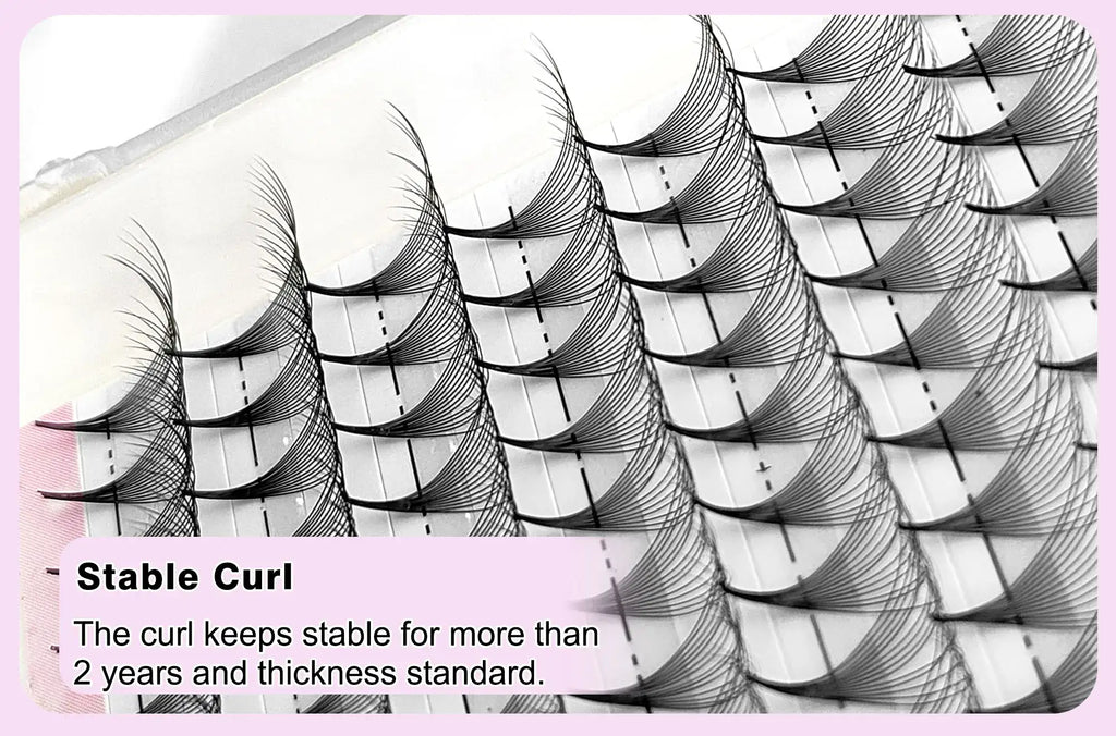Black synthetic volume eyelash extension fans arranged in rows on a sticky tray for professional application.