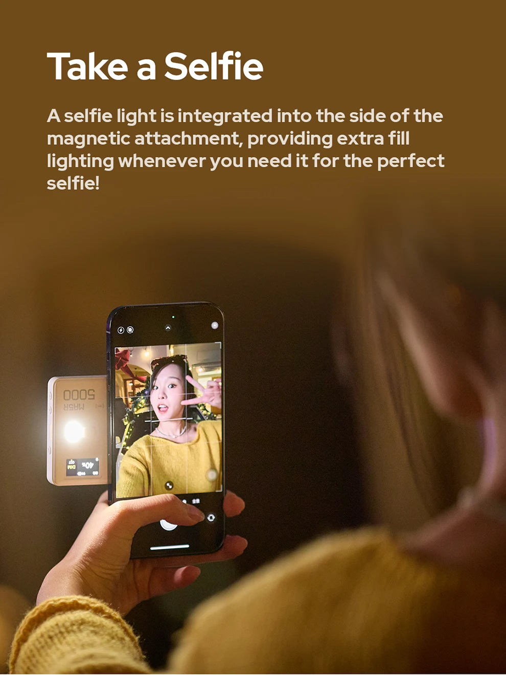 White, rectangular magnetic LED fill light attached to a smartphone to provide extra lighting for taking selfies.