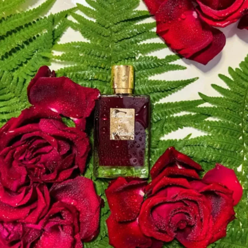 By Kilian 50ml unisex EDP, woody floral spicy niche fragrance in a luxe rectangular bottle surrounded by red roses.