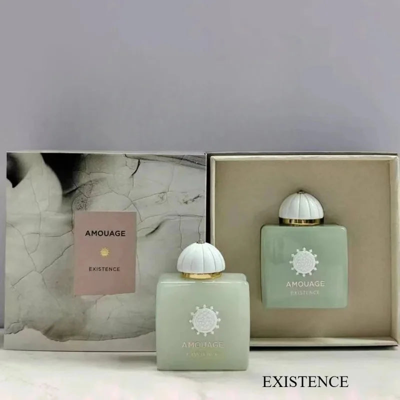 Amouage Existence perfume set: square pastel green glass bottle with white cap and elegant floral box packaging.
