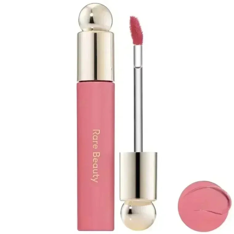 Rare Beauty matte liquid lipstick in pink with applicator wand, showcasing smooth texture and rich color swatch.