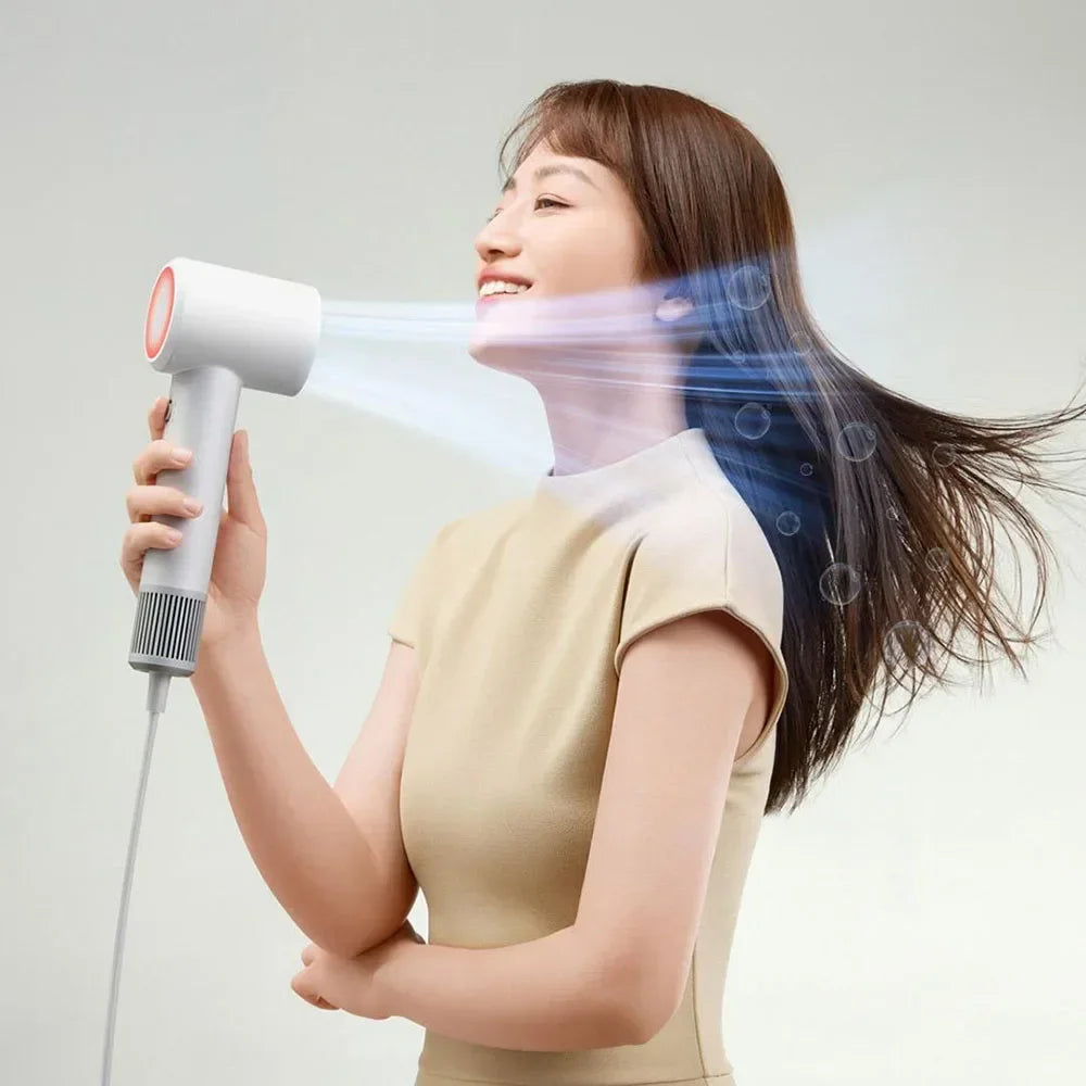 Woman drying hair with white MIJIA H501SE high-speed hair dryer featuring powerful 110,000 RPM airflow and sleek design.