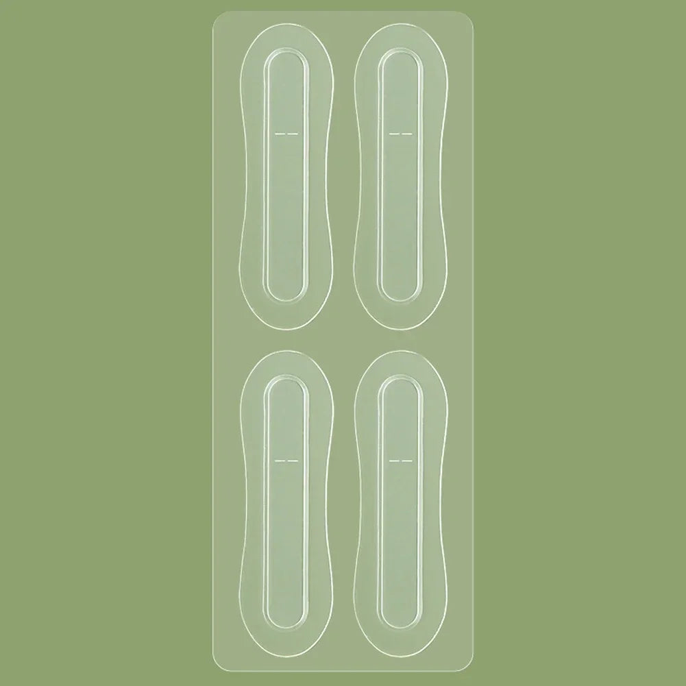 Four clear, oval-shaped adhesive Tidesmit ear support patches arranged in two rows on a plastic backing sheet.