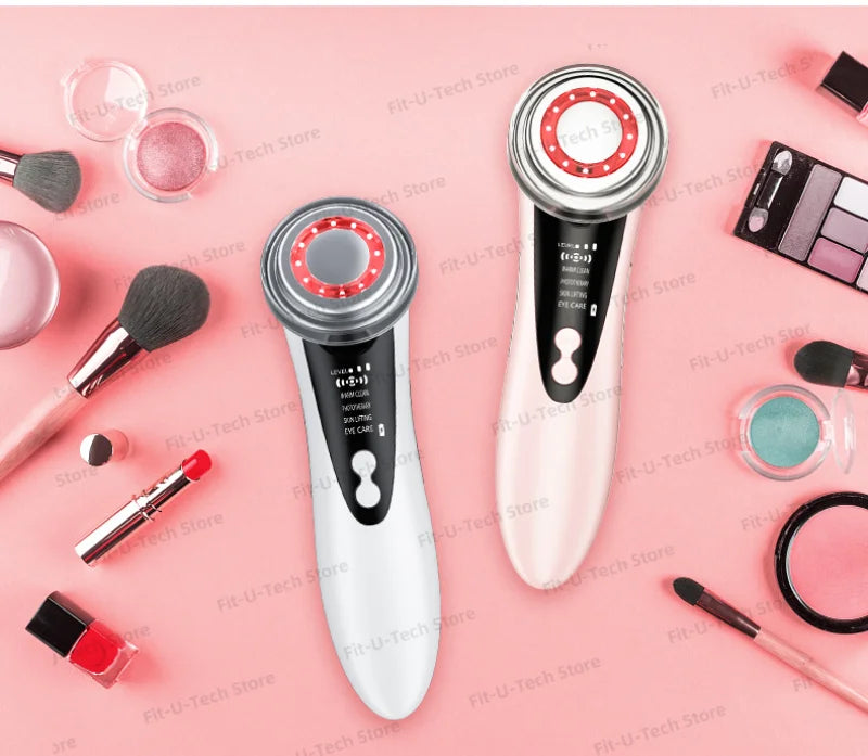 Two handheld LED facial massagers in white and pink, featuring circular heads and digital displays on a pink makeup
