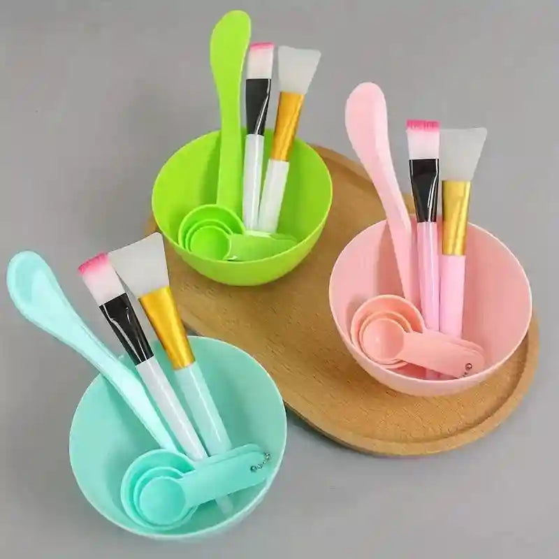 Three 7-piece DIY face mask tool sets in green, pink, and mint, each with a bowl, spoons, spatula, and brushes.