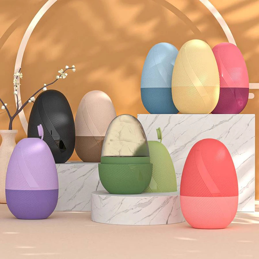 An assortment of egg-shaped ice rollers in various colors, displayed on white marble-patterned pedestals.