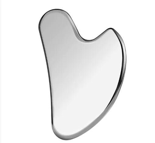 A smooth, heart-shaped gua sha massage tool made of reflective, polished stainless steel.