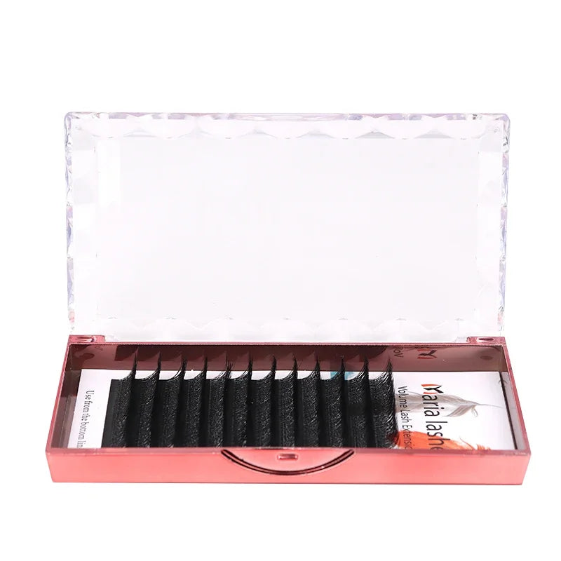 Black 5D W-style volume lash extension strips in a rose gold metallic case with a clear, faceted lid.