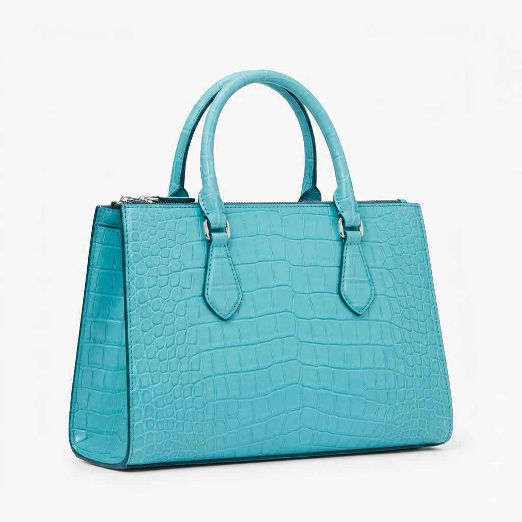 Turquoise crocodile embossed genuine leather designer handbag with dual top handles and silver hardware.