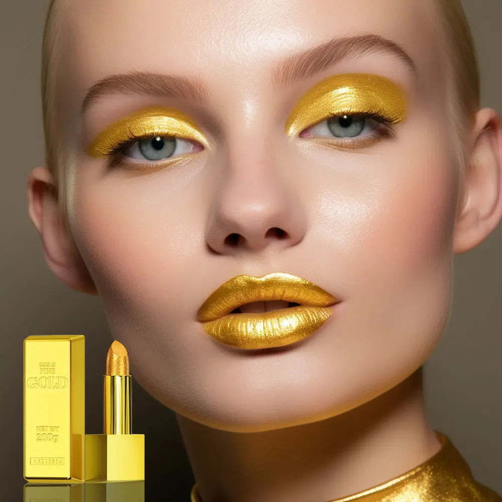 Model wearing long-lasting metallic gold shimmer lipstick in a gold brick tube packaging.