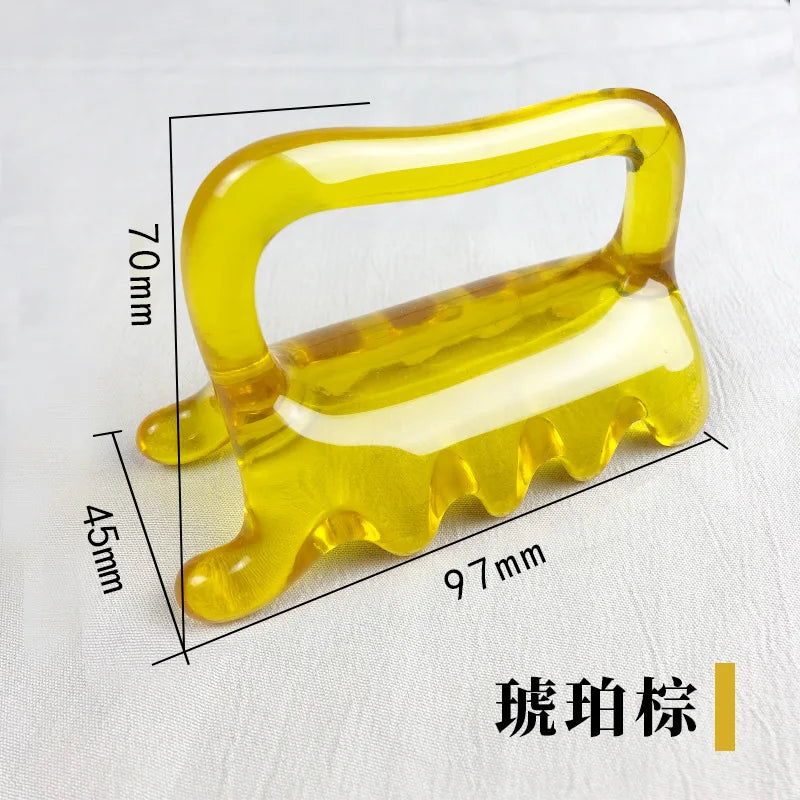Yellow amber-colored resin massage tool with a handle and multiple curved points, measuring 97x70x45mm.