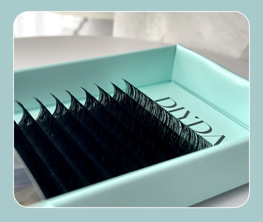 Tray of black DIYDAY individual mink lashes with a natural curl, presented in a sleek light blue packaging case.