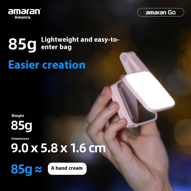 Small, pale pink folding LED light for photography, held in hand, measuring 9.0 x 5.8 x 1.6 cm and weighing 85g.