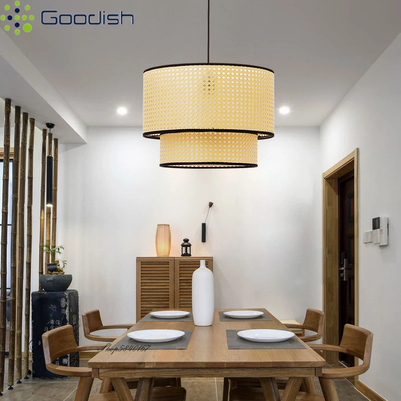 Two-tiered rattan pendant lamp with a natural weave and black trim, hanging over a wooden dining room table.