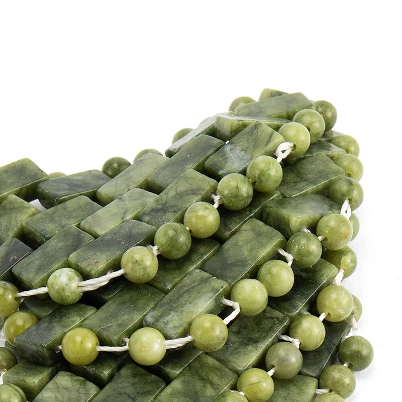 Natural green jade stone cooling eye mask for relaxation, crafted with rectangular tiles and round beads on white.
