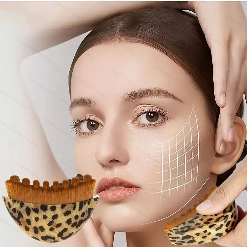 A woman holds a curved, leopard-print lymphatic contouring face brush with soft brown bristles against her jawline.