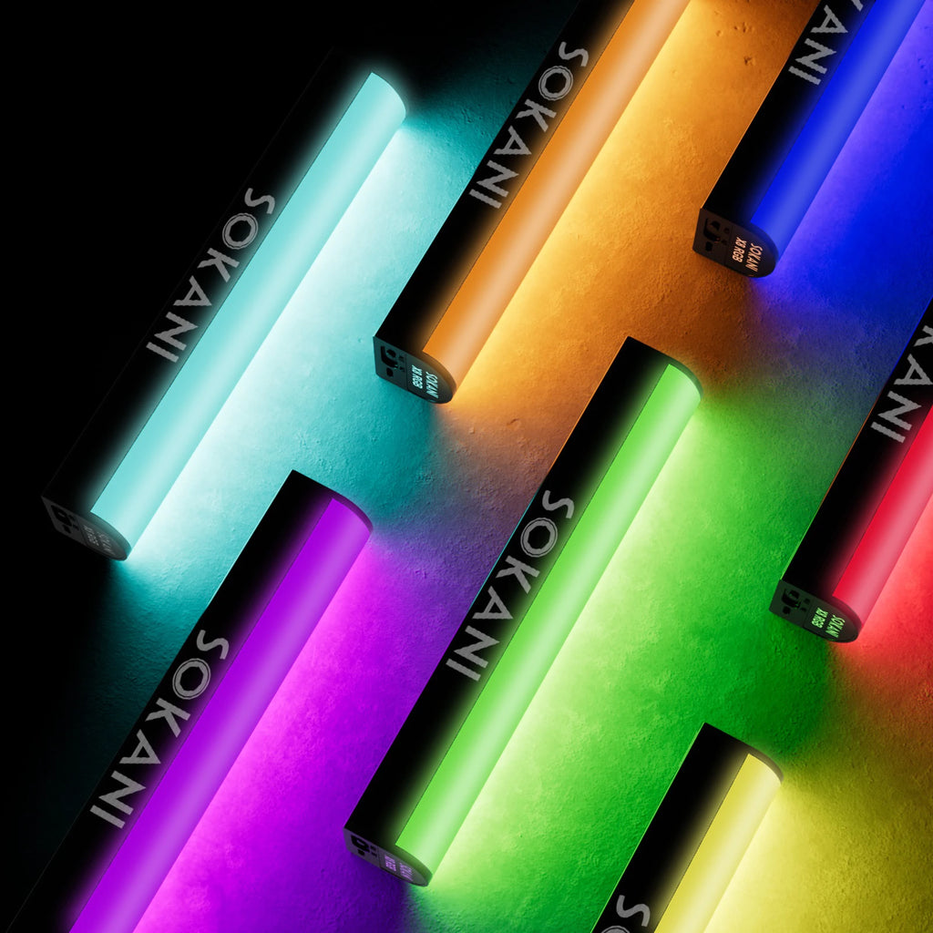 Six slender, rectangular RGB LED light wands glowing in various colors against a dark background.