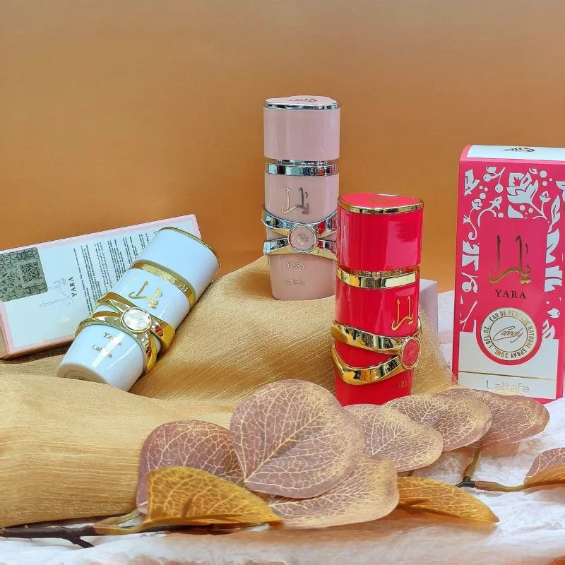 Lattafa Yara 30ml Eau de Parfum: Unisex floral, orchid, and oud scent in elegant gold-accented cylindrical bottles.