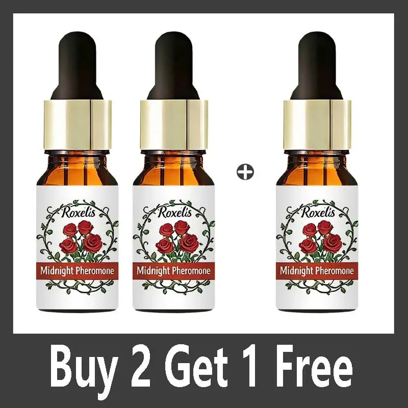 Three small amber glass dropper bottles of Midnight Pheromone fragrance, featuring rose illustrations and gold caps.